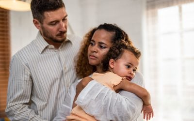 a mother holding her child and the father.
